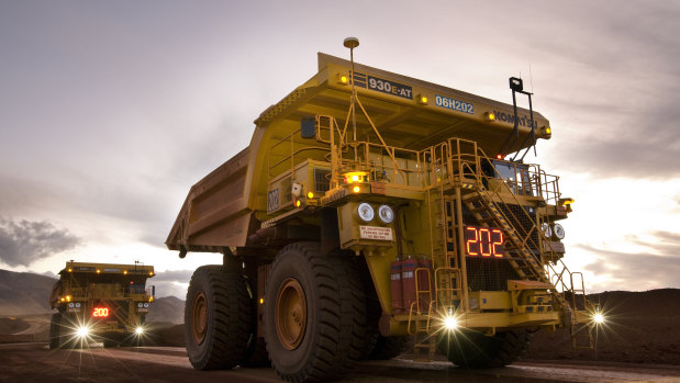 Autonomous trucks rumble past at Rio's West Angelas mine in the Pilbara.