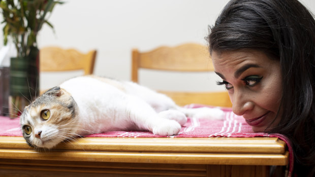 Maysoon Zayid with her cat at her home in Edgewater, New Jersey.