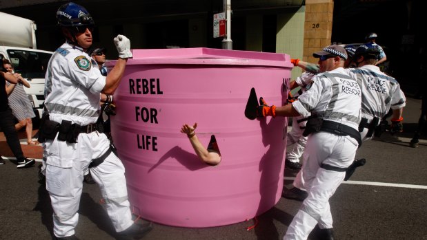 Protesters are moved by police in Sydney. 