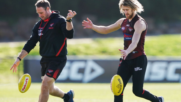 One-two step: Ben Rutten (left) with Essendon captain Dyson Heppell.