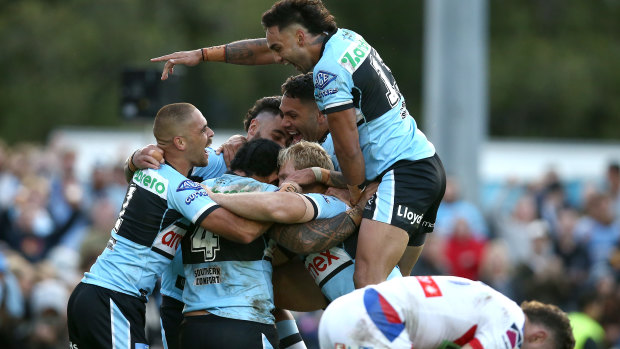 The Sharks celebrate Aiden Tolman’s try in his 300th NRL game.