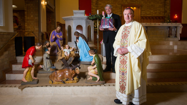 Archbishop Christopher Prowse
preparing to deliver Christmas messages in the cathedral. Pictured with CEO of St vincent de Paul society Canberra Goulburn, Barnie van Wyk.
