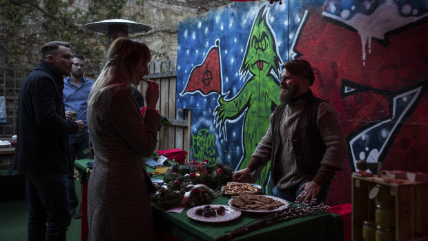 Alex Malenki, right, and his wife, Ingrid Weiss, at a Christmas market hosted by Generation Identity, a far-right youth movement, in Halle, Germany.