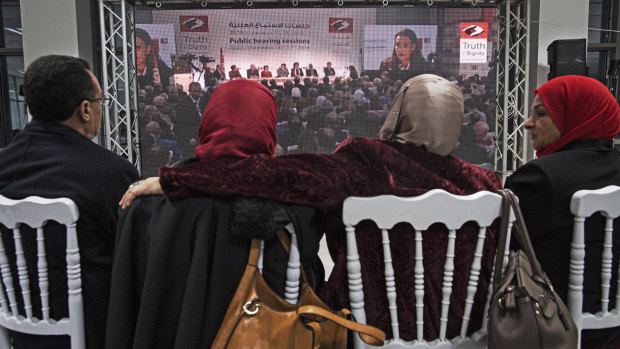 Hamida Ajengui, centre left, a former Islamist activist tortured under Zine al-Abidine Ben Ali’s dictatorship, listens to other victims at the Truth and Dignity Commission in 2016.