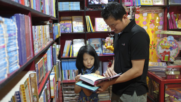 Customers browse through books at DSB Books.