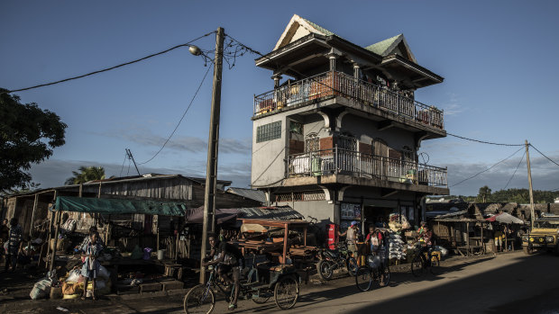 A so-called vanilla mansion looms above a street in Antalaha, Madagascar.