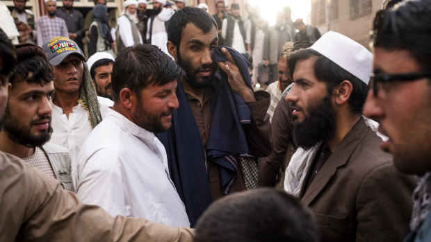 Zindani, centre, and his friend Kitab, in white, at a mosque during a discussion with marchers and other worshippers.  