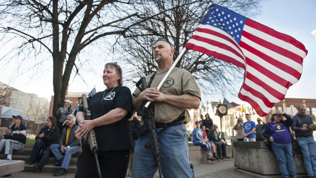 Western Pennsylvania has gone all in for Trump.  National Rifle Association instructor Marilyn Boulet, left, and her husband, Bill Perkins, of Gibsonia, rest their hands on their guns while gathering with other supporters of the Second Amendment outside Pittsburgh. 