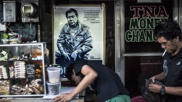 'A leader must be a terror to the few who are evil': A poster for President Duterte on the window of a store in Manila.