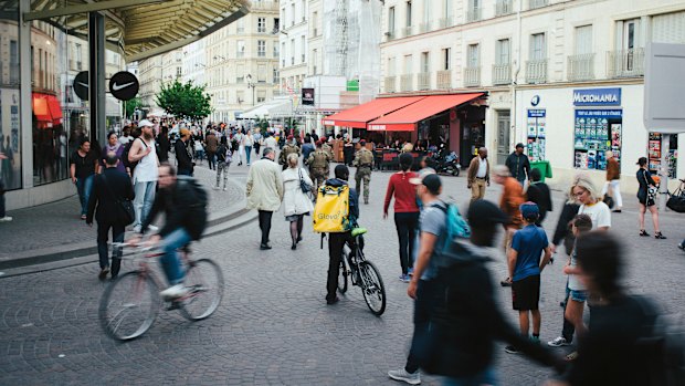 A Glovo food delivery courier waits for an order at Les Halles in Paris.