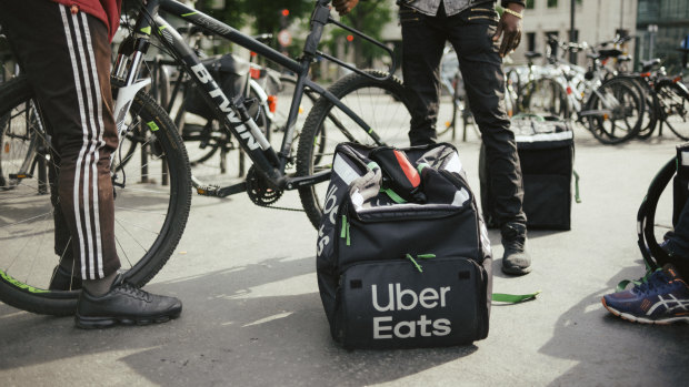 Couriers wait for food orders at the Place d’Italie in Paris.