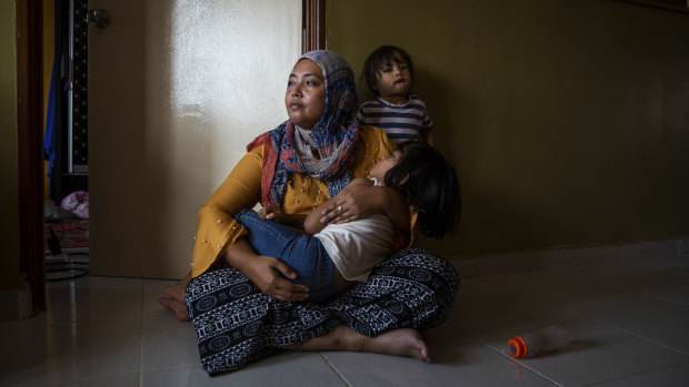 Siti Nor Azila, the second wife of Che Abdul Karim Che Abdul Hamid, with her two daughters in her family’s home in Gua Musang town in Kelantan, Malaysia.