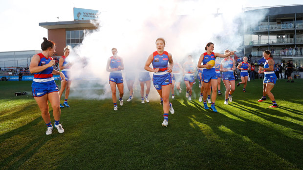 The Bulldogs run onto the field for their round one match against the Demons.