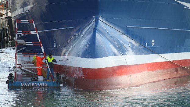 Workers clean Lunar Bow, one of the largest trawlers in Peterhead harbour.