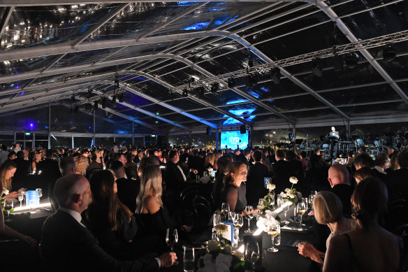 Culbert addresses guests in a gigantic marquee at the gala dinner. 