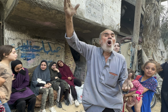 Palestinian survivors react in front of the rubble of their family building, following Israeli airstrike in Nusseirat refugee camp in Gaza Strip.