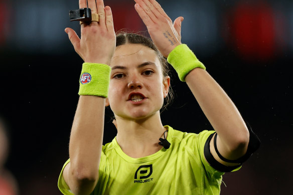 Field umpire Emma Stark signals during the match.