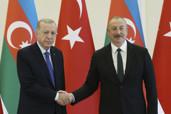 Azerbaijani President Ilham Aliyev (right) with Turkish counterpart Recep Tayyip Erdogan on June 13 in Baku.