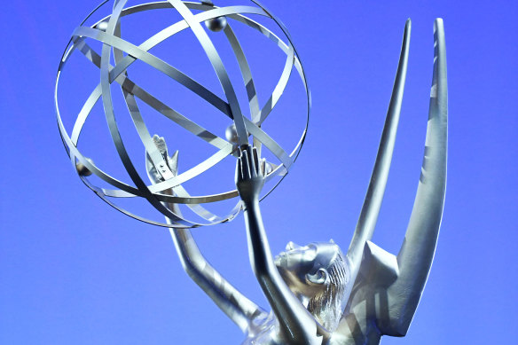 The muse of art, upholding the electron of science, also known as the Emmy.