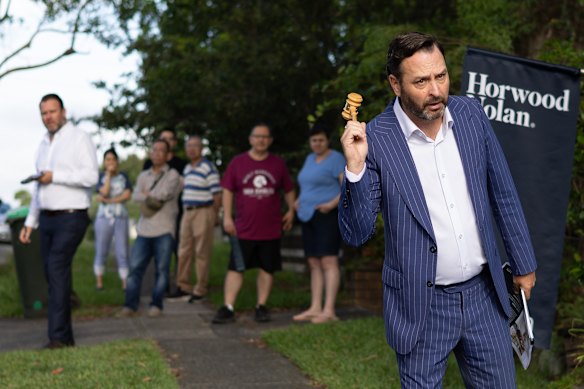 Cooleys auctioneer Ben Mitchell led bidders through the auction on Shipley Avenue on a humid Saturday.