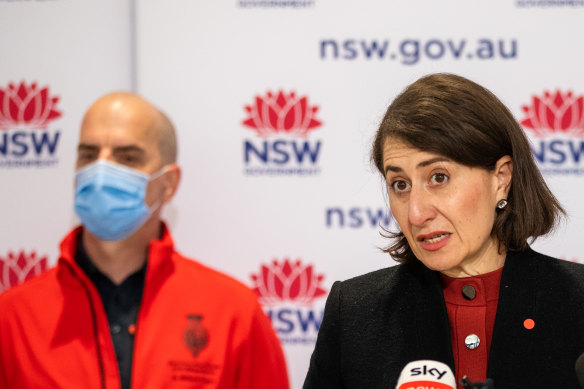 NSW Premier Gladys Berejiklian has clarified her position on vaccines and state borders. Royal Prince Alfred Hospital ICU doctor Richard Totaro watches on.