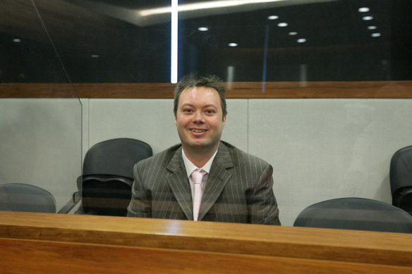 Carl Williams smiling in the dock in court before his sentencing in 2007. 