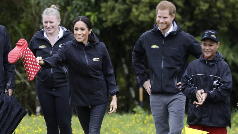 Meghan, Duchess of Sussex competes in a 'gumboot-throwing' contest following a ceremony to dedicate a 20-hectare area of native bush to the Queen's Commonwealth Canopy in Auckland,.