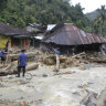 Rescuers search for victims following a flash flood in Mandailing Natal district.