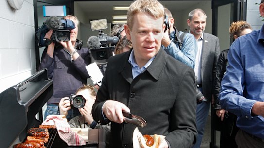 Election sausage: NZ PM Chris Hipkins hands food on Monday.