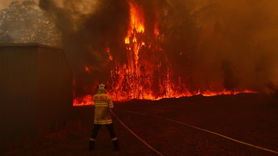 Firefighters protect property on Lakes Way, north of Forster.