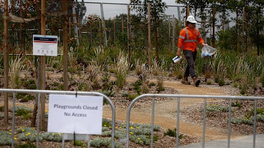 Employees of John Holland and CPB contractors collect asbestos samples for the EPA (Environmental Protection Authority) after asbestos was found in the mulch.