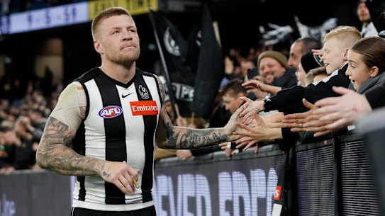 Jordan De Goey celebrates with Magpies fans.