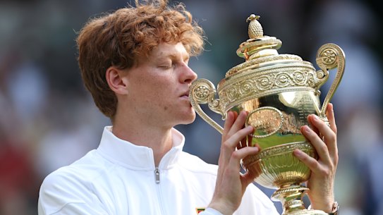 Jannik Sinner kisses the famous trophy.