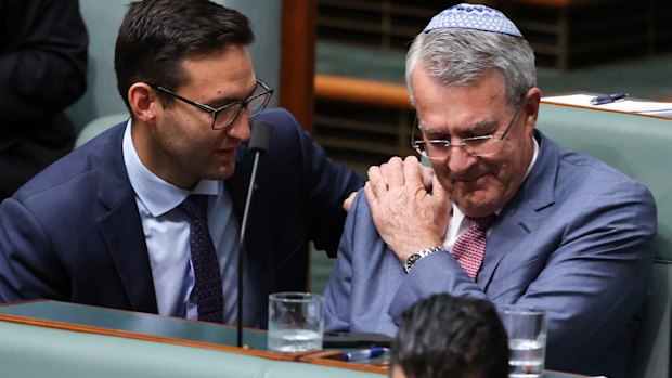 Labor MP Josh Burns consoles Mark Dreyfus after he spoke during a condolence motion for the victims of the Bondi antisemitic terror attack.