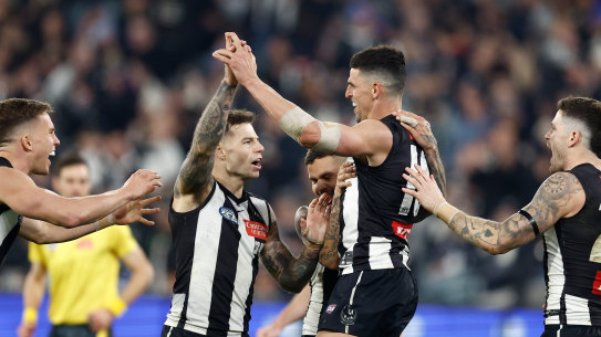 Collingwood champion Scott Pendlebury celebrates with his Magpie teammates.