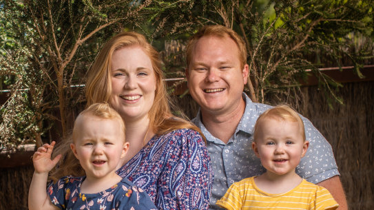 Andrew and Alana Spencer and their two-year-old twins Aurora (in yellow) and Bexley (in blue) 