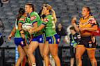 Raiders players celebrate a try against the Wests Tigers.