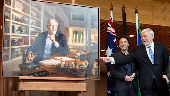 Former Prime Minister Kevin Rudd (right) during the unveiling of his official portrait by Ralph Heimans (left), at Parliament House in Canberra. 