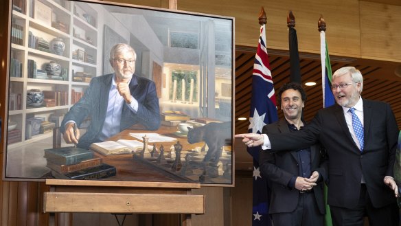 Former Prime Minister Kevin Rudd (right) during the unveiling of his official portrait by Ralph Heimans (left), at Parliament House in Canberra. 