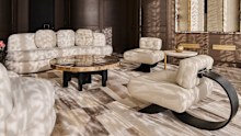 A pair of Brazilian modernist Oscar Niemeyer Alta chairs in ivory leather set off a living area.