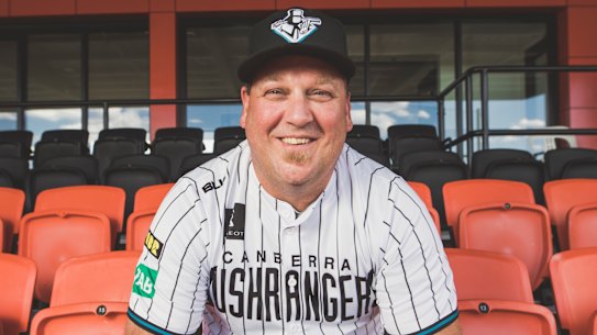Canberra Cavalry coach Michael Wells wears the replica of the Canberra Bushrangers uniform from the 1990s.
