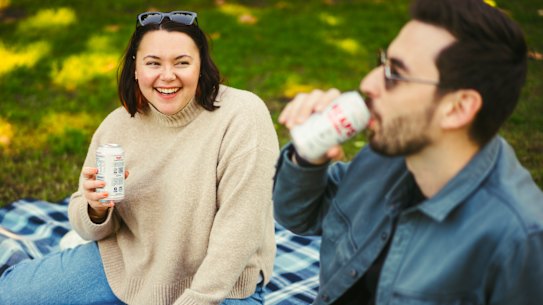 Lauran Vohmann abd her partner Alistair Brown enjoying non-alcoholic beer at Brennan Park in Wollstonecraft. 