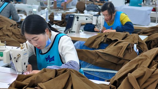 Workers sewing clothing for export at an garment factory in Donghai county in east China's Jiangsu province. China's economic growth held steady in the latest quarter despite a tariff war with Washington, suggesting Beijing's efforts to reverse a slowdown might be gaining traction.