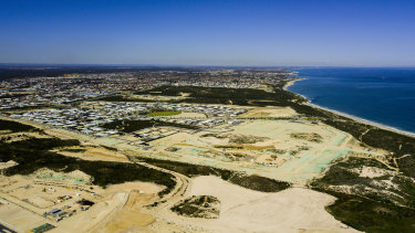 This drone shot shows a south-facing view of Alkimos Beach near Yanchep. Perth's skyline is just visible on the horizon, and the stretch of the coastal suburbs can be seen clearly.