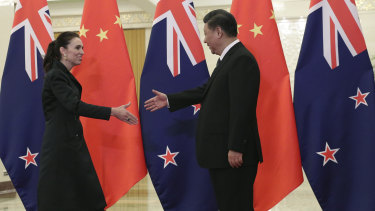 Chinese President Xi Jinping, right, and New Zealand Prime Minister Jacinda Ardern shake hands before their meeting at the Great Hall of the People in Beijing.