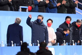 Xi Jinping, President of China, waves at the crowd during the opening ceremony. 
