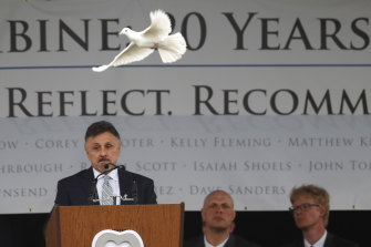 A dove flies over Frank DeAngelis, who was principal of Columbine High School during the attack 20 years ago.