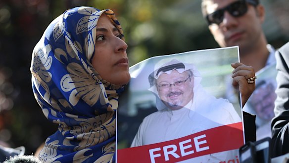 Holding a picture of missing Saudi writer Jamal Khashoggi, Tawakkol Karman, the Nobel Peace Prize laureate for 2011, talks to members of the media near the Saudi Arabia consulate in Istanbul, on Friday.