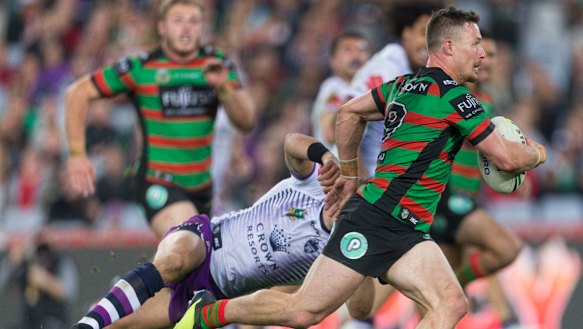 Star turn: Damien Cook shrugs off some desperate Storm defence to score at ANZ Stadium.