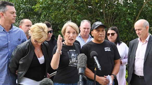 Loved ones of those who died, Andrew Murphy, Jennie Ross-King, Julie Tam,  John Tam and Cornelius Brosnan, with supporters and family members behind them, speak outside the NSW Coroners Court.